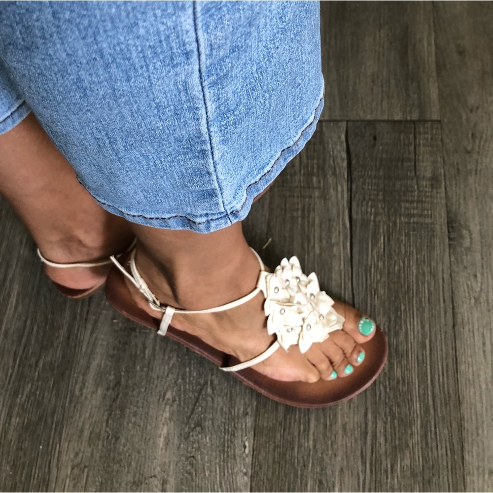 White sandals with flowers on top